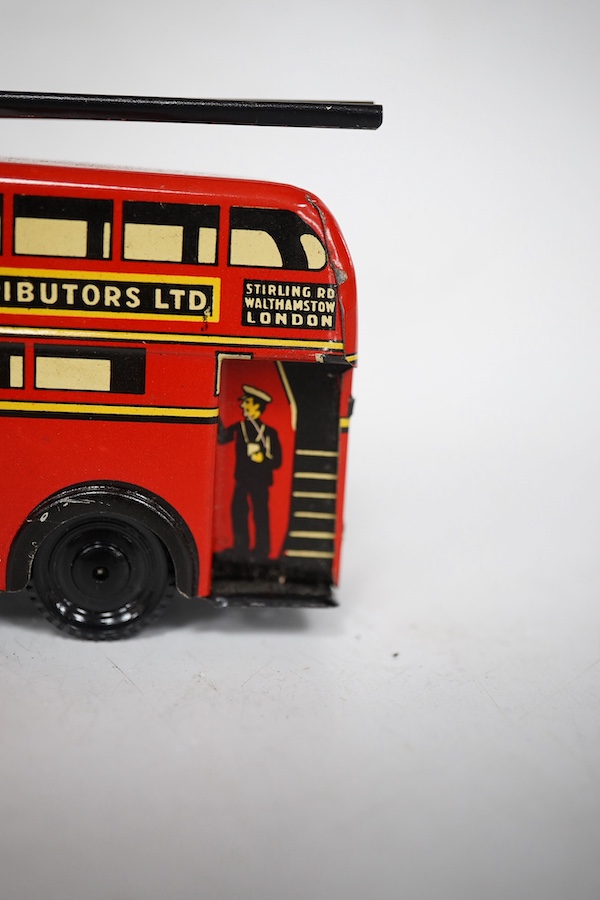 A boxed Wells Brimtoy tinplate clockwork trolley bus loosely in London Transport livery, together with three keys. Condition fair to good, clockwork motor appears to work correctly although has lost grip on the driving a